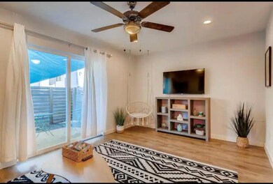 Living room featuring baseboards, wood finished f