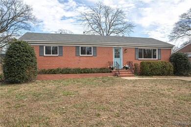 Single story home featuring brick siding and a fro