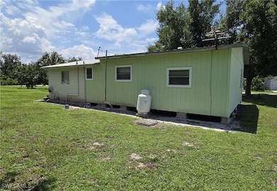 Back of house featuring a yard