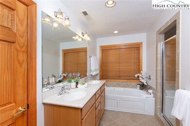 The master suite includes double sinks, tiled show