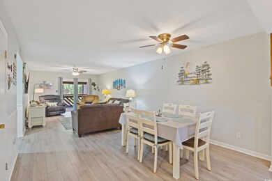 Dining room with baseboards, light wood-style flooring, and ceiling fan