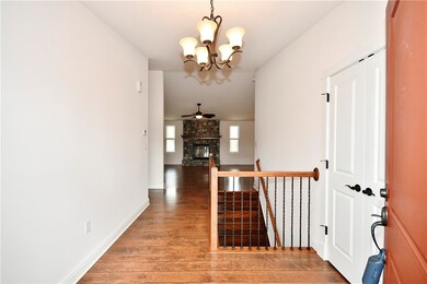 Main Level Entry with Focal Fireplace & Open Stair