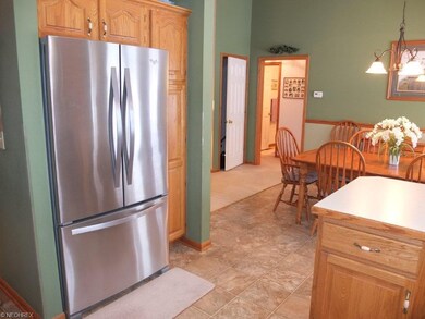 Kitchen open to dining room and living room with v