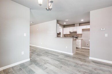 Kitchen with white cabinets, light hardwood / wood