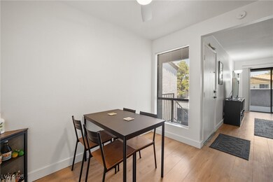 Dining area featuring ceiling fan, light wood fini