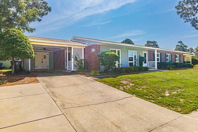 Ranch-style home with a carport and a front yard
