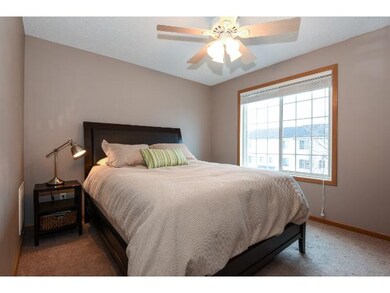 Upper bedroom with walk-in closet and ceiling fan.