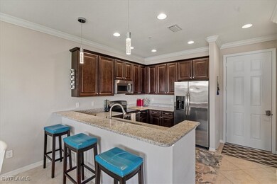 Kitchen with light stone countertops, appliances w