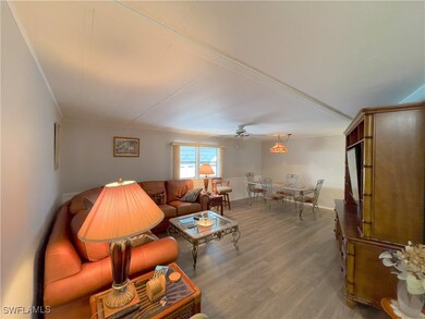 Living room featuring ceiling fan and hardwood / w