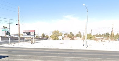 View of asphalt street featuring street lighting a