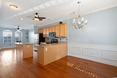 Kitchen featuring kitchen peninsula, hardwood / wo