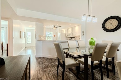 Living room with lofted ceiling, hardwood / wood-style floors, and ceiling fan