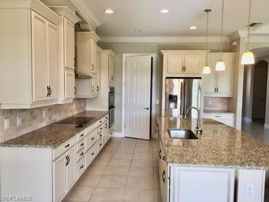 Kitchen featuring stainless steel refrigerator wit
