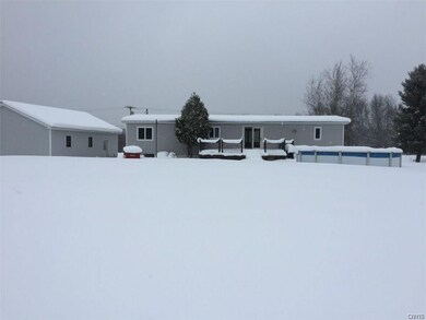 Back of home with deck and pool