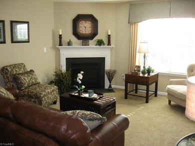 Living room with gas fireplace: image similar to finished home.