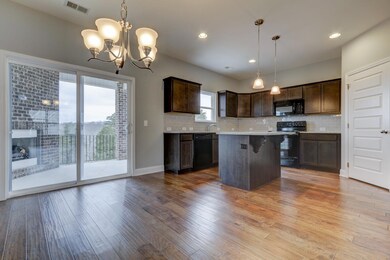 Kitchen w/ island and outdoor fireplace