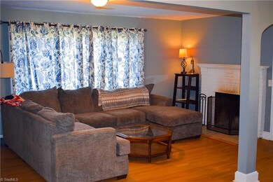 Large living room with wood-burning fireplace and tons of natural light.