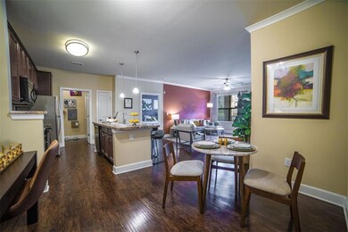 Dining area featuring sink, dark wood-type floorin