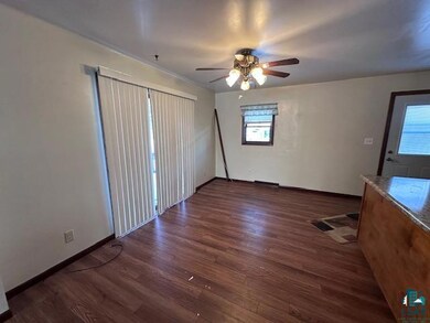 Interior space featuring ceiling fan and dark wood