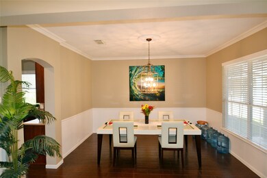 Formal dining room with large windows looking out to the front porch.