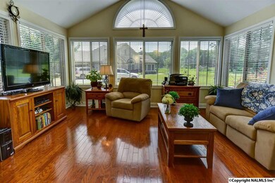 surround this MAGNIFICENT sunroom! The plentiful natural sunlight amplifies the STUNNING hardwoods that grace this home, and the vaulted ceiling makes the room appear even LARGER.