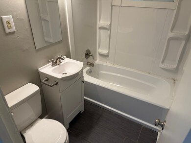 Bathroom with toilet, vanity, and tub / shower combination
