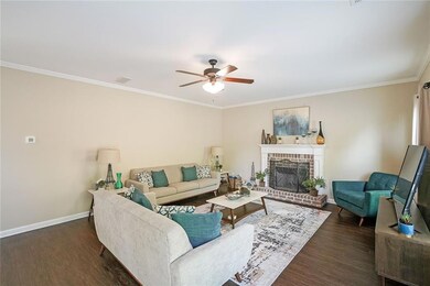 Living area featuring a brick fireplace, wood fini