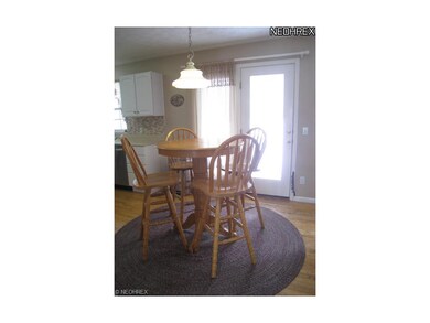 Dinette with hardwood floor.
