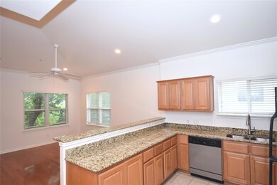 Kitchen featuring light stone countertops, a sink