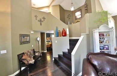Two-story ceiling & dark hardwood flooring