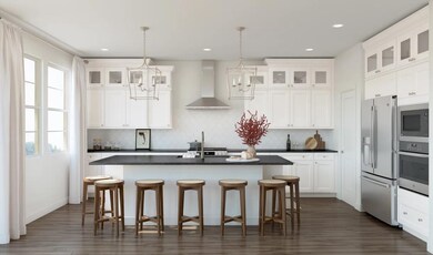 Kitchen with island, pendant lighting and glass upper cabinets