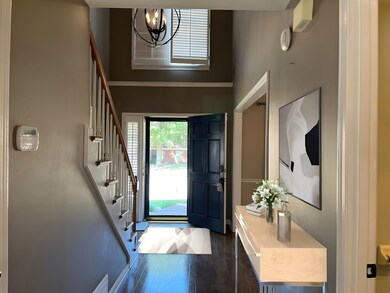 This area has been virtually staged. Entryway feat