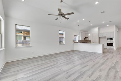 Unfurnished living room featuring lofted ceiling,