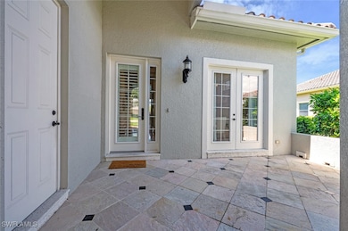 View of exterior entry featuring a patio area, fre