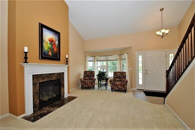 Living room with gas fireplace and vaulted ceiling