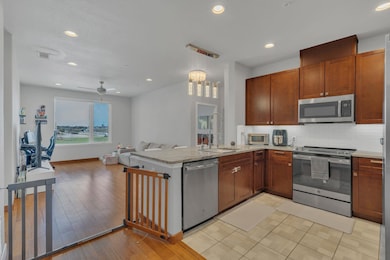 Kitchen featuring decorative backsplash, light woo