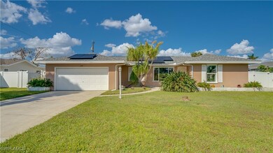 Ranch-style house with solar panels, a garage, and