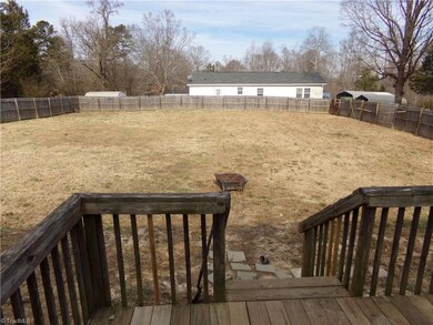 View of large fenced in back yard
