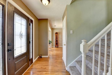 Entrance foyer featuring stairs and light wood finished floors