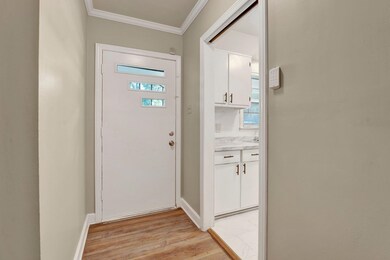 Doorway with light hardwood / wood-style flooring 