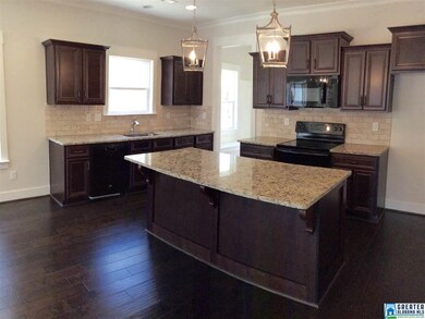 Gourmet kitchen features granite countertops, work