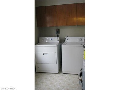 Large utility/mud room with newer hot water tank, furnace and washer/dryer