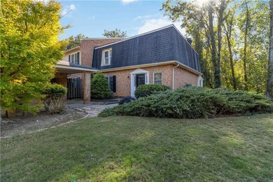 Colonial inspired home with brick siding, a shingl