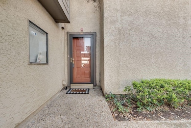 Doorway to property with stucco siding