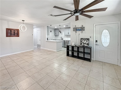 Foyer entrance with light tile patterned floors, a
