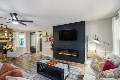 Step inside to a Bright, Open Main Living Area featuring Luxury Flooring, Fresh Paint, and Designer Touches Throughout.
