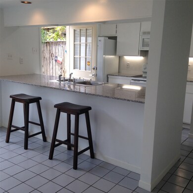open to the kitchen with a breakfast bar