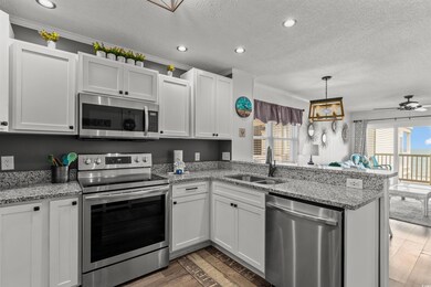 Kitchen with white cabinetry, kitchen peninsula, d