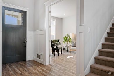 Entrance foyer featuring stairway, wood finished floors, and plenty of natural light