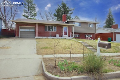 Tri-level home with concrete driveway, a chimney, 